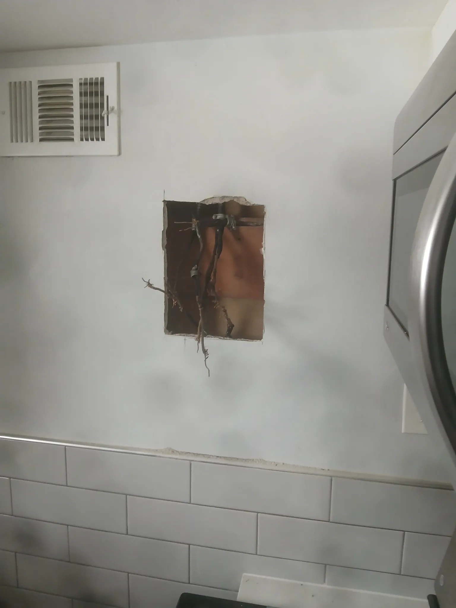 Before: exposed wiring and wall damage